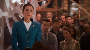 Movie still from “Snowpiercer” (2020), created by Graeme Manson – A group of people standing in front of a crowd; Medium shot, Over the shoulder angle