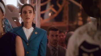 Movie still from “Snowpiercer” (2020), created by Graeme Manson – A woman in a blue suit standing in front of a crowd; Medium shot, Over the shoulder angle