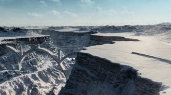 Movie still from “Snowpiercer” (2020), created by Graeme Manson – An aerial view of a snow covered landscape; Extreme Wide shot, High angle