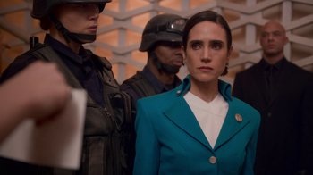 Movie still from “Snowpiercer” (2020), created by Graeme Manson – A woman standing next to two other men in a room; Medium shot, Over the shoulder angle