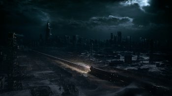 Movie still from “Snowpiercer” (2020), created by Graeme Manson – A train traveling through a dark city at night; Extreme Wide shot, High angle