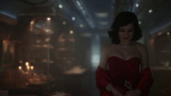 Movie still from “Snowpiercer” (2020), created by Graeme Manson – A woman in a strapless red dress holding onto a purse; Medium shot, Over the shoulder angle