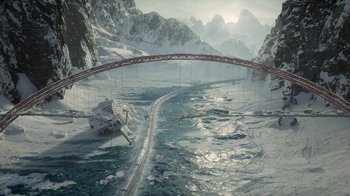 Movie still from “Snowpiercer” (2020), created by Graeme Manson – An aerial view of a bridge in the middle of a snowy landscape; Extreme Wide shot, High angle