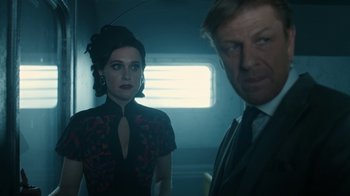 Movie still from “Snowpiercer” (2020), created by Graeme Manson – A man and a woman standing next to each other in a room; Medium shot, Low angle