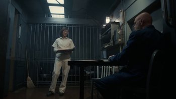 Movie still from “Snowpiercer” (2020), created by Graeme Manson – A woman standing in front of a man sitting at a table; Wide shot, Low angle