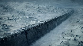 Movie still from “Snowpiercer” (2020), created by Graeme Manson – A train traveling through the snow covered mountains; Extreme Wide shot, Low angle