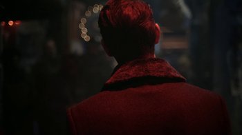 Movie still from “Snowpiercer” (2020), created by Graeme Manson – A man in a red jacket is looking out a window; Close Up shot, Over the shoulder angle