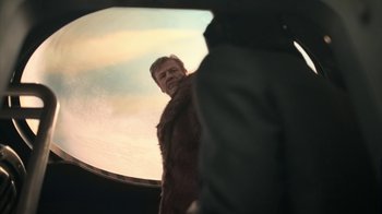 Movie still from “Snowpiercer” (2020), created by Graeme Manson – A man standing in front of a round mirror; Medium shot, Over the shoulder angle