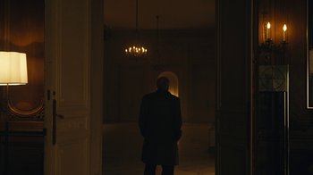 Movie still from “Mr. Robot” (2015), created by Sam Esmail – A man standing in a dark room with a light shining on him; Wide shot, Low angle