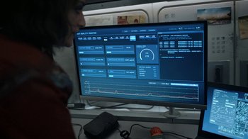 Movie still from “Snowpiercer” (2020), created by Graeme Manson – A man sitting in front of a computer monitor; Extreme Close Up shot, Over the shoulder angle