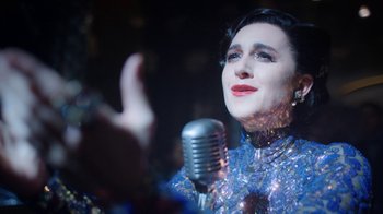 Movie still from “Snowpiercer” (2020), created by Graeme Manson – A woman holding a microphone up to her face; Close Up shot, Over the shoulder angle