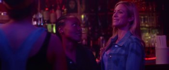 Movie still from “Someone Great” (2019), directed by Jennifer Kaytin Robinson – A man and a woman are standing in a bar; Close Up shot, Over the shoulder angle