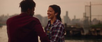 Movie still from “Someone Great” (2019), directed by Jennifer Kaytin Robinson – A man and a woman are smiling and holding hands; Medium shot, Over the shoulder angle