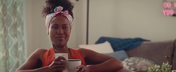 Movie still from “Someone Great” (2019), directed by Jennifer Kaytin Robinson – A woman sitting at a table holding a cup of coffee; Close Up shot, Over the shoulder angle