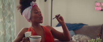 Movie still from “Someone Great” (2019), directed by Jennifer Kaytin Robinson – A woman sitting in front of a bowl of food; Medium shot, Over the shoulder angle