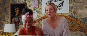 Movie still from “Someone Great” (2019), directed by Jennifer Kaytin Robinson – Two women sitting next to each other in front of a computer; Medium shot, Over the shoulder angle