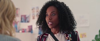 Movie still from “Someone Great” (2019), directed by Jennifer Kaytin Robinson – A person with a curly hair; Close Up shot, Over the shoulder angle