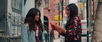 Movie still from “Someone Great” (2019), directed by Jennifer Kaytin Robinson – Two young women standing next to each other on the sidewalk; Medium shot, Over the shoulder angle