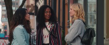 Movie still from “Someone Great” (2019), directed by Jennifer Kaytin Robinson – Two women are talking on the sidewalk of a city street; Medium shot, Over the shoulder angle