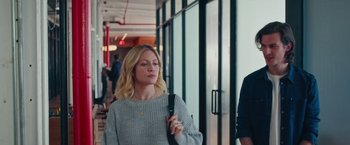 Movie still from “Someone Great” (2019), directed by Jennifer Kaytin Robinson – A woman in a gray sweater is holding a phone; Medium shot, Over the shoulder angle