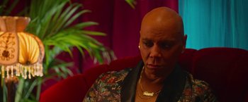 Movie still from “Someone Great” (2019), directed by Jennifer Kaytin Robinson – A bald woman sitting on a red couch; Close Up shot, High angle