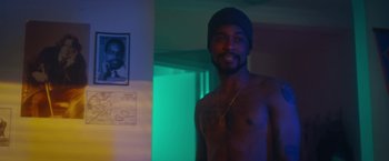 Movie still from “Someone Great” (2019), directed by Jennifer Kaytin Robinson – A man with a beard and a hat is posing for a picture; Medium shot, Over the shoulder angle