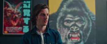 Movie still from “Someone Great” (2019), directed by Jennifer Kaytin Robinson – A man in front of a painting of a gorilla; Close Up shot, Low angle