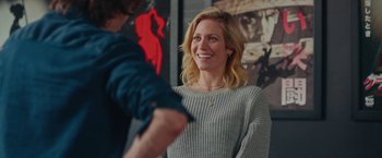 Movie still from “Someone Great” (2019), directed by Jennifer Kaytin Robinson – A woman in a gray sweater smiling at a man in a blue shirt; Medium shot, Over the shoulder angle