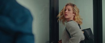 Movie still from “Someone Great” (2019), directed by Jennifer Kaytin Robinson – A woman standing in front of a mirror with her hair blowing in the wind; Medium shot, Low angle