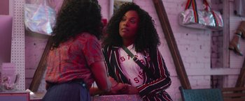 Movie still from “Someone Great” (2019), directed by Jennifer Kaytin Robinson – A woman standing next to another woman in front of a mirror; Medium shot, Over the shoulder angle