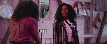 Movie still from “Someone Great” (2019), directed by Jennifer Kaytin Robinson – A woman standing next to another woman in front of a mirror; Medium shot, Over the shoulder angle