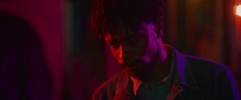 Movie still from “Someone Great” (2019), directed by Jennifer Kaytin Robinson – A man with dreadlocks is looking down at his face; Close Up shot, Over the shoulder angle