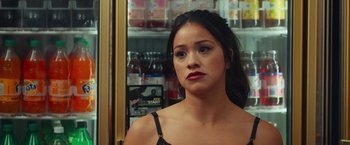 Movie still from “Someone Great” (2019), directed by Jennifer Kaytin Robinson – A young woman with dark brown hair and red lipstick looking at the camera; Close Up shot, Over the shoulder angle