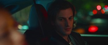 Movie still from “Someone Great” (2019), directed by Jennifer Kaytin Robinson – A man sitting in the back seat of a car; Close Up shot, Over the shoulder angle