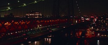 Movie still from “Someone Great” (2019), directed by Jennifer Kaytin Robinson – A view of a bridge at night from a boat; Extreme Wide shot, High angle