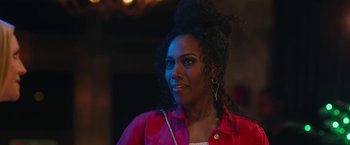 Movie still from “Someone Great” (2019), directed by Jennifer Kaytin Robinson – A woman in a red shirt is looking at the camera; Close Up shot, Over the shoulder angle