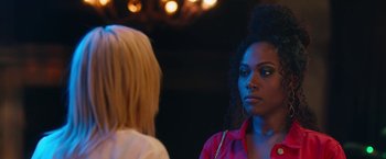 Movie still from “Someone Great” (2019), directed by Jennifer Kaytin Robinson – Two women are talking in a dark room; Close Up shot, Over the shoulder angle