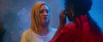 Movie still from “Someone Great” (2019), directed by Jennifer Kaytin Robinson – A woman is looking into a mirror while another woman looks on; Close Up shot, Over the shoulder angle