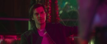 Movie still from “Someone Great” (2019), directed by Jennifer Kaytin Robinson – A man in a purple jacket standing next to a tree; Close Up shot, Over the shoulder angle