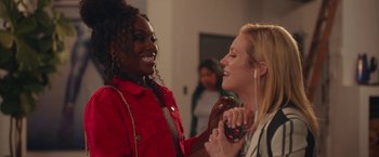 Movie still from “Someone Great” (2019), directed by Jennifer Kaytin Robinson – Two women are talking and laughing while one of them is holding a cell phone; Medium shot, Over the shoulder angle