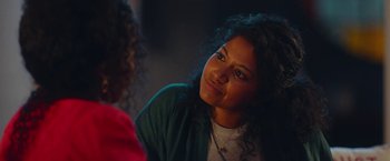 Movie still from “Someone Great” (2019), directed by Jennifer Kaytin Robinson – A woman sitting in front of another woman in a room; Close Up shot, Over the shoulder angle