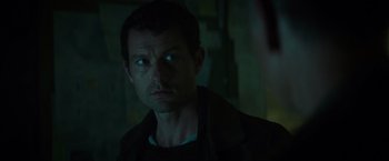 Movie still from “Spectral” (2016), directed by Nic Mathieu – A person looking at the camera; Close Up shot, Over the shoulder angle