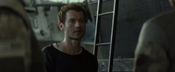 Movie still from “Spectral” (2016), directed by Nic Mathieu – A person standing next to a ladder; Close Up shot, Low angle