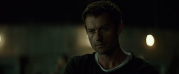 Movie still from “Spectral” (2016), directed by Nic Mathieu – A person wearing a black shirt; Close Up shot, Over the shoulder angle