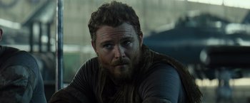 Movie still from “Spectral” (2016), directed by Nic Mathieu – A person with a beard; Close Up shot, Over the shoulder angle