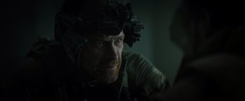 Movie still from “Spectral” (2016), directed by Nic Mathieu – A person wearing a helmet; Close Up shot, Over the shoulder angle