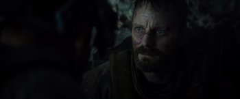 Movie still from “Spectral” (2016), directed by Nic Mathieu – A person with a beard looking at the camera; Close Up shot, Over the shoulder angle