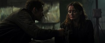 Movie still from “Spectral” (2016), directed by Nic Mathieu – A man and a woman with blood on their face; Close Up shot, Over the shoulder angle