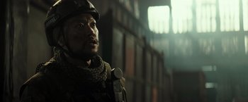 Movie still from “Spectral” (2016), directed by Nic Mathieu – A man in a military uniform is looking at the camera; Close Up shot, Low angle