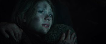 Movie still from “Spectral” (2016), directed by Nic Mathieu – A young girl with green eyes is holding a teddy bear; Close Up shot, Low angle